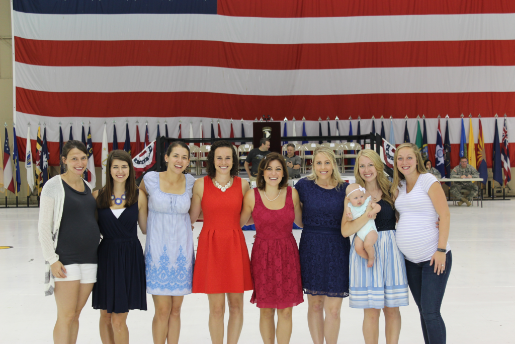 military spouses against backdrop of american flag