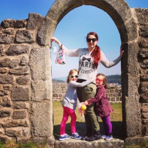 girls with mother in arch of castle ruins