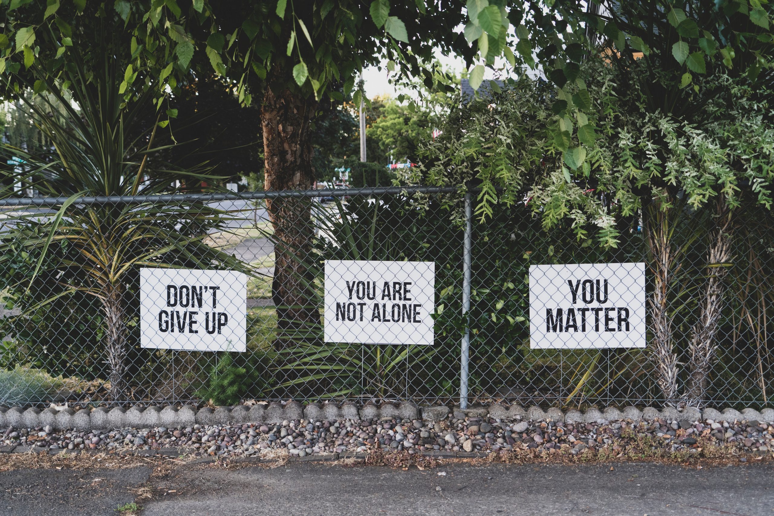 inspirational posters on fence