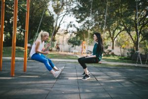 two women on swings