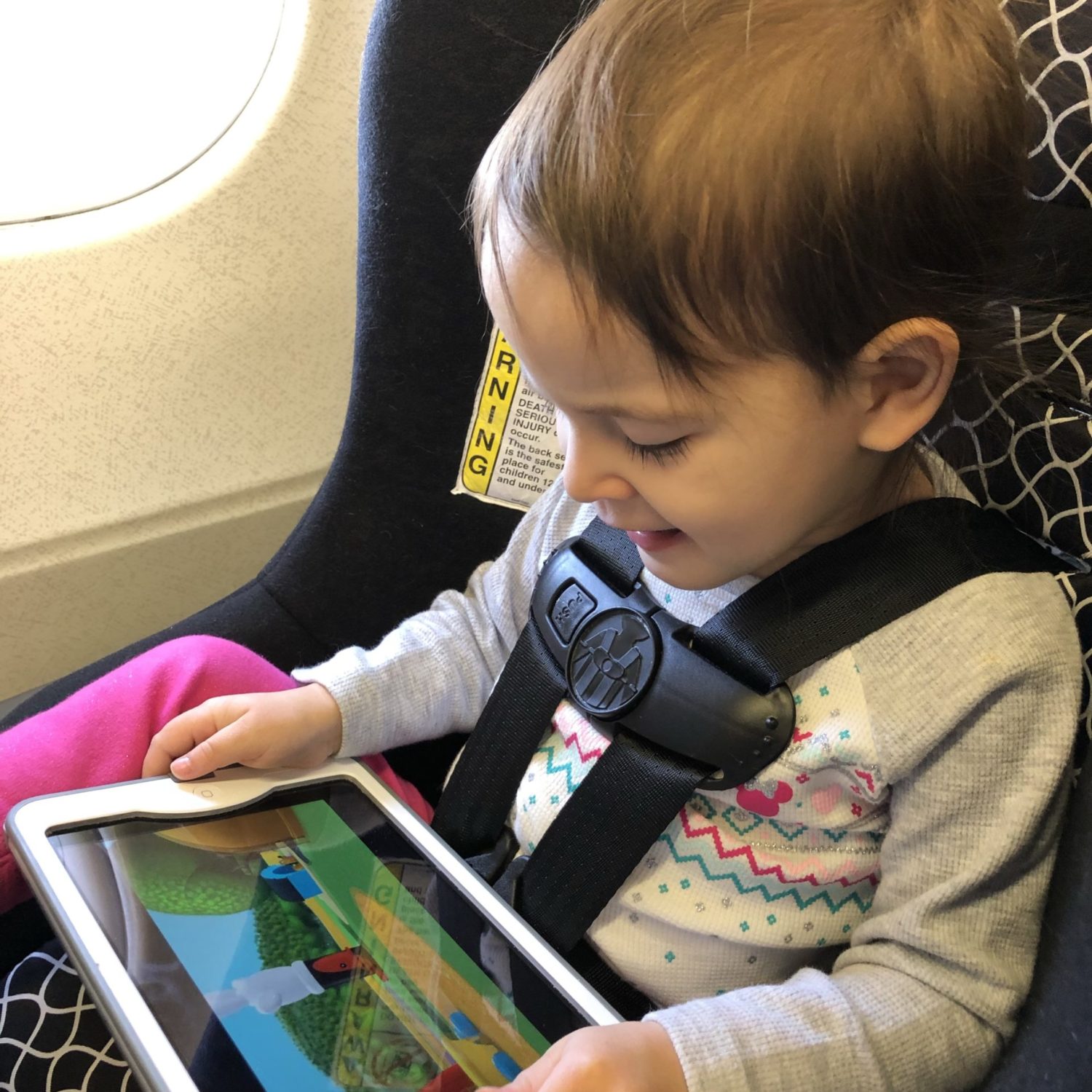 traveling with small child in car seat with iPad