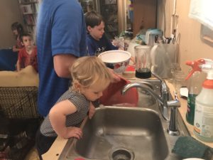 dad and kids doing dishes practicing lead me, guide me parenting