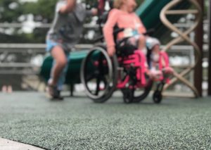 Boy pushing wheelchair