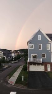 rainbow above house in neighborhood