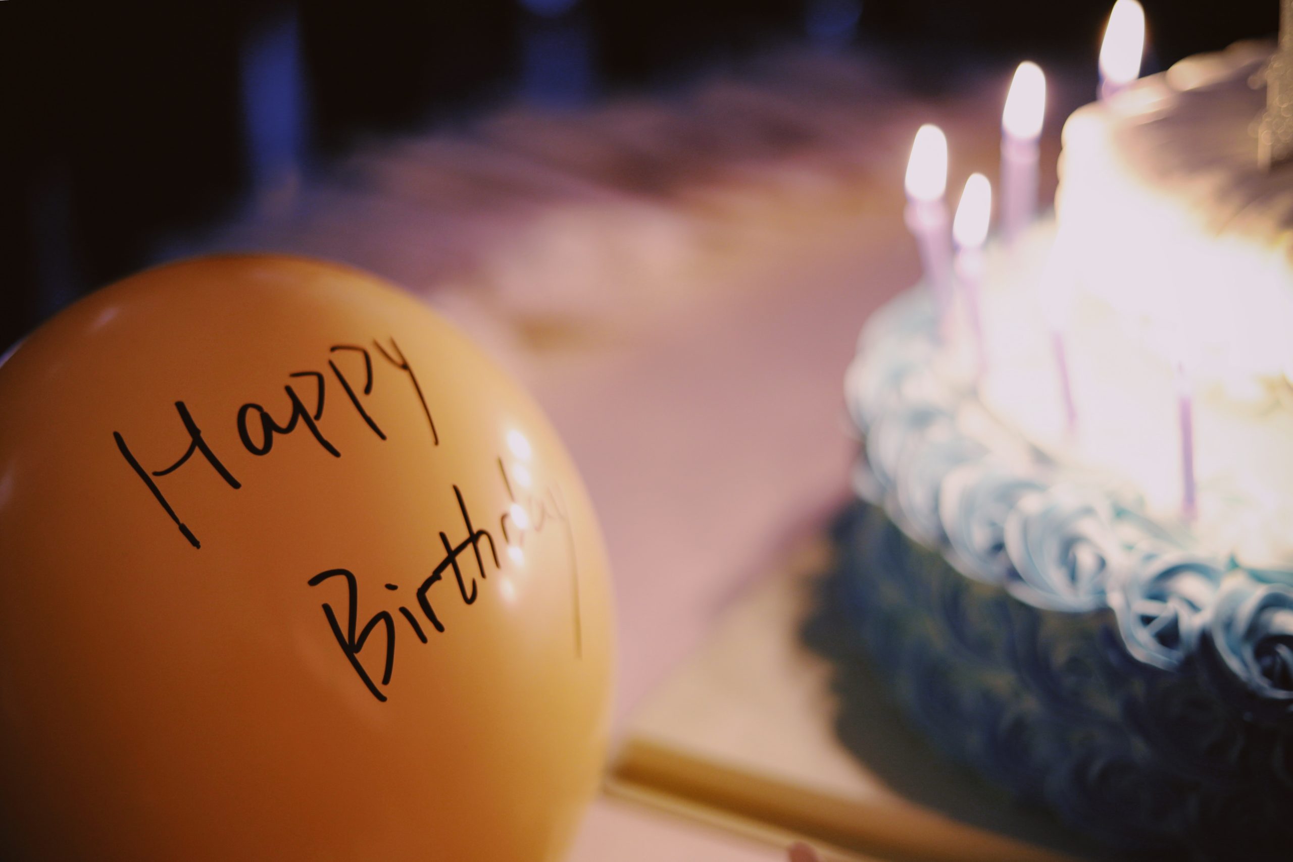 happy birthday balloon with cake in background