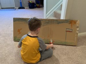 boy playing with recycled art