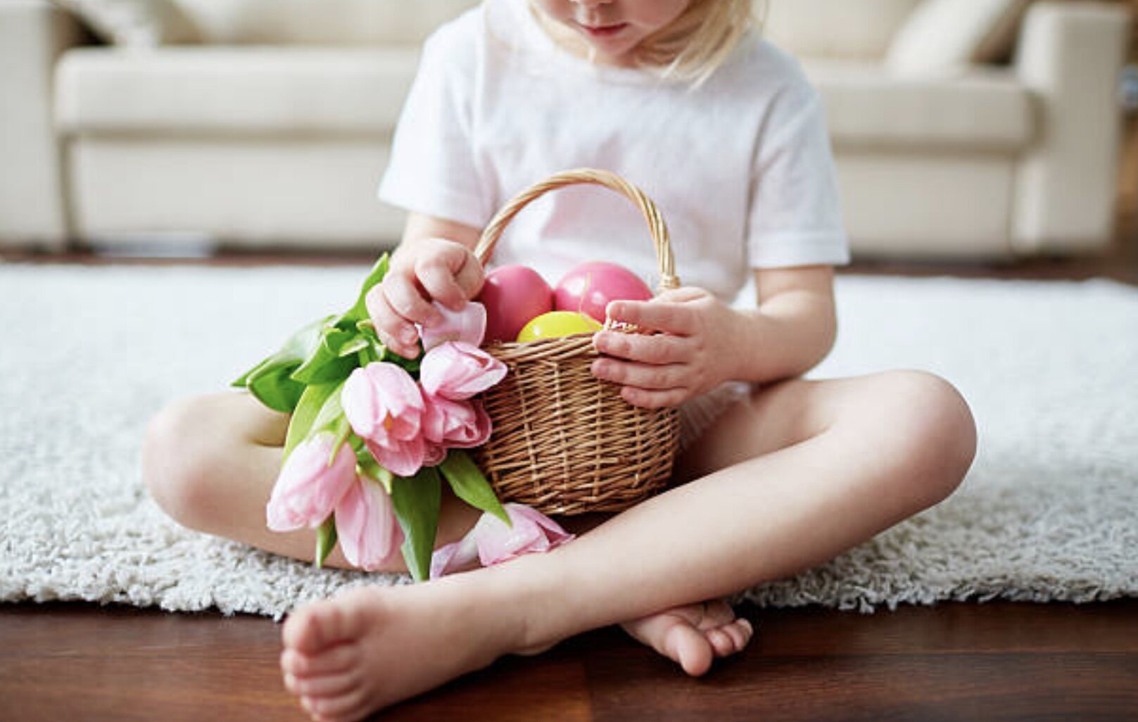 child holding easter basket with flowers