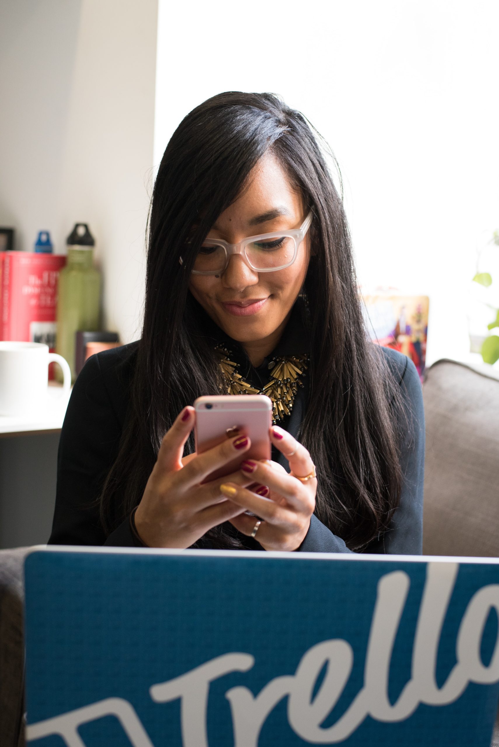 woman on phone in front of computer