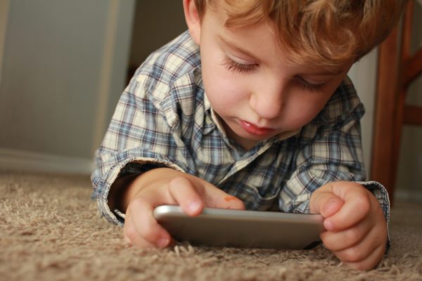 small child fixated on phone screen