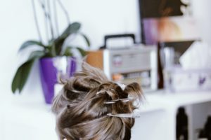 woman getting a haircut in salon