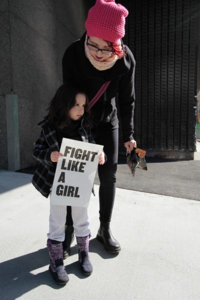 girl and mother at protest using voice