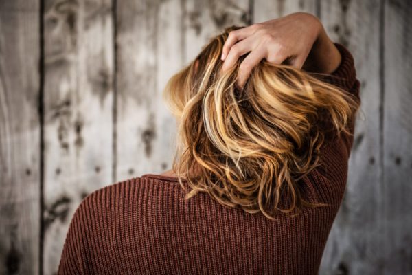 hair cut on woman with barn-style background