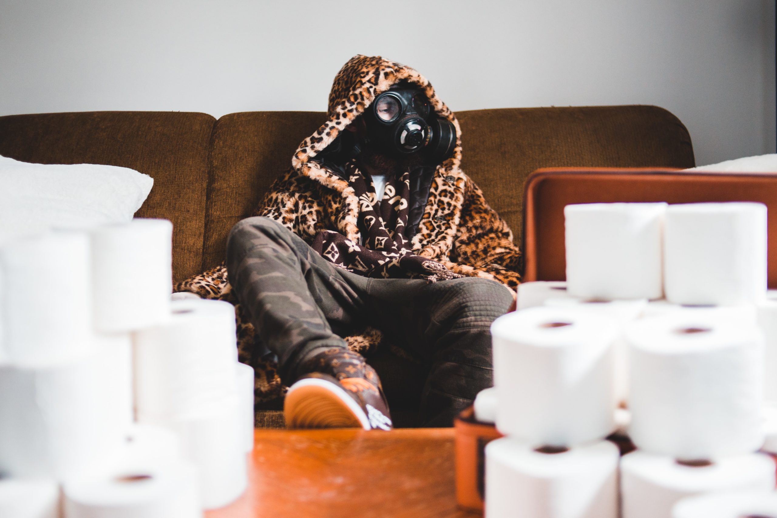 man with mask surrounded by toilet paper