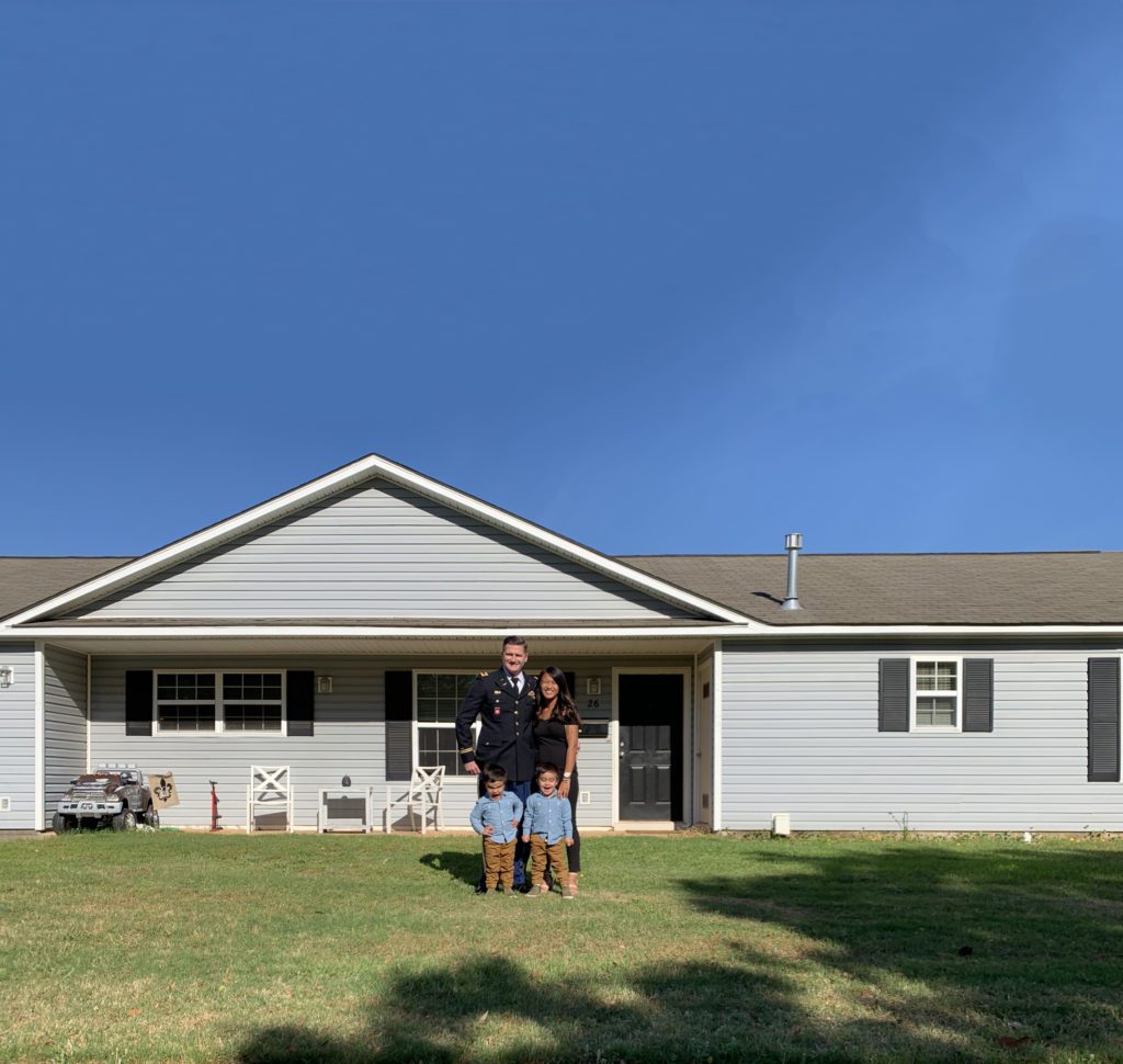 military family in front of their home