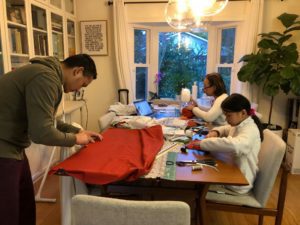 family making masks at table