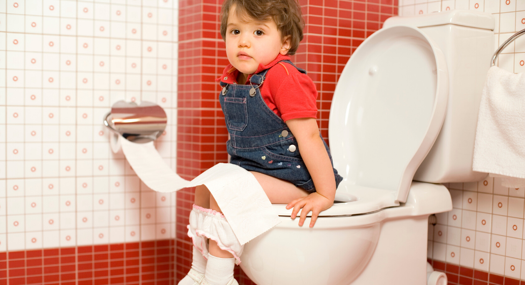 young child sitting on the potty