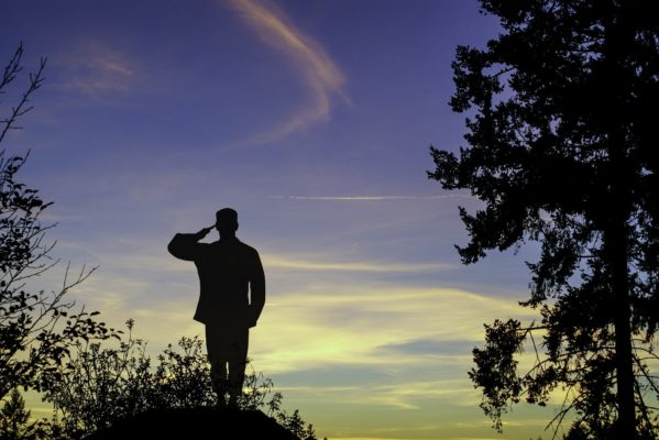 Army soldier saluting in the setting sun