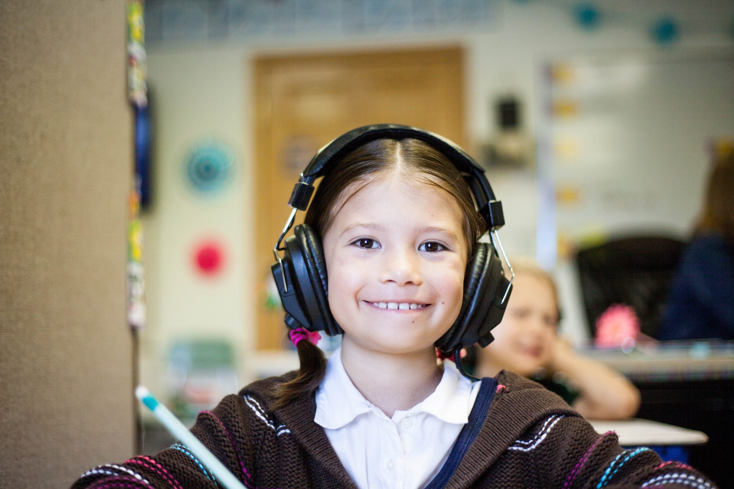 child with headphones on at school