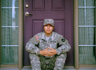 American soldier sitting on doorstep