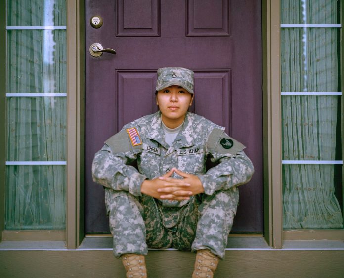 American soldier sitting on doorstep