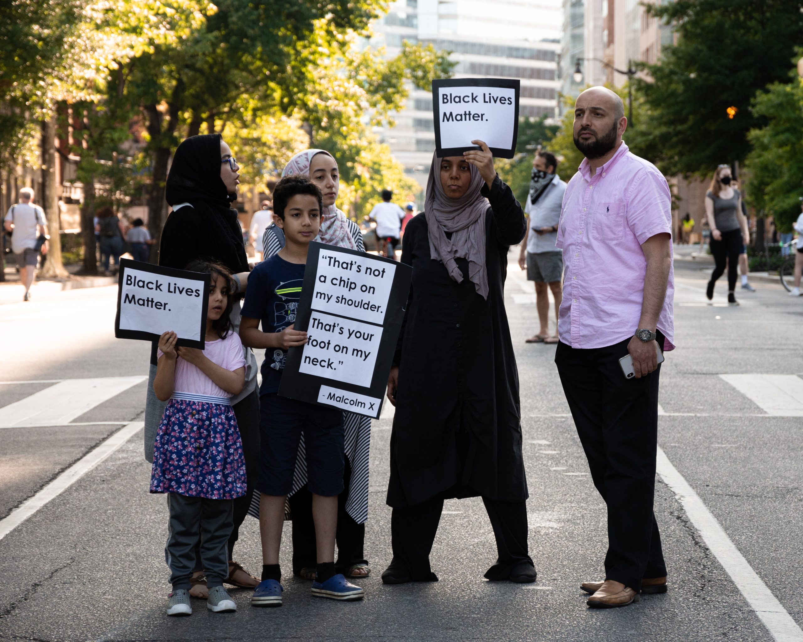 Arabic family with signs at a black lives matter protest