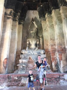 Mom and kids in front of a sculpture in Thailand