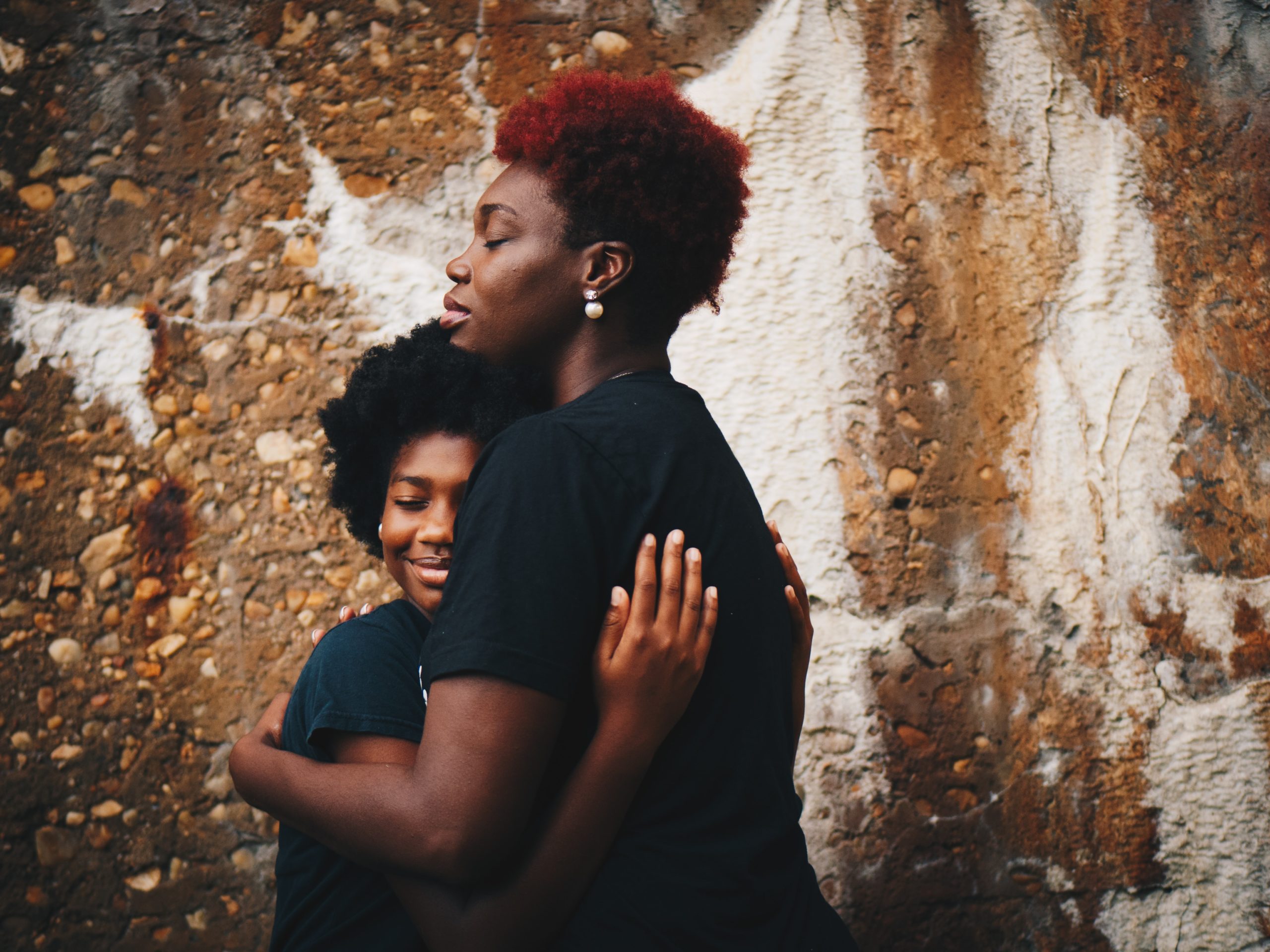 mother hugging teenage daughter