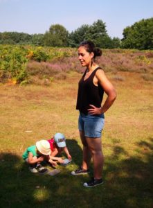 woman standing in shorts with children