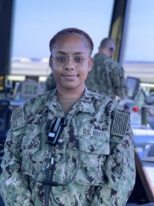 Woman in military uniform stainding in air traffic control tower