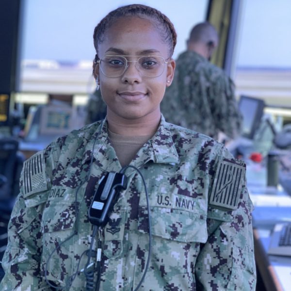 Woman in military uniform stainding in air traffic control tower