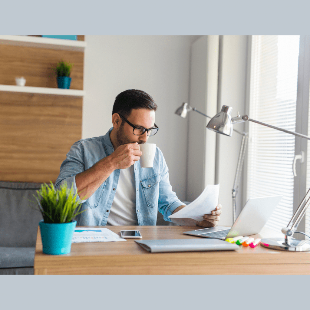 man with coffee working