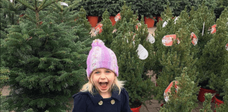 Girl smiling and excited in Christmas Tree lot