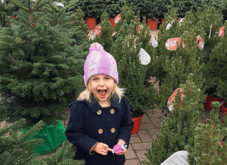 Girl smiling and excited in Christmas Tree lot