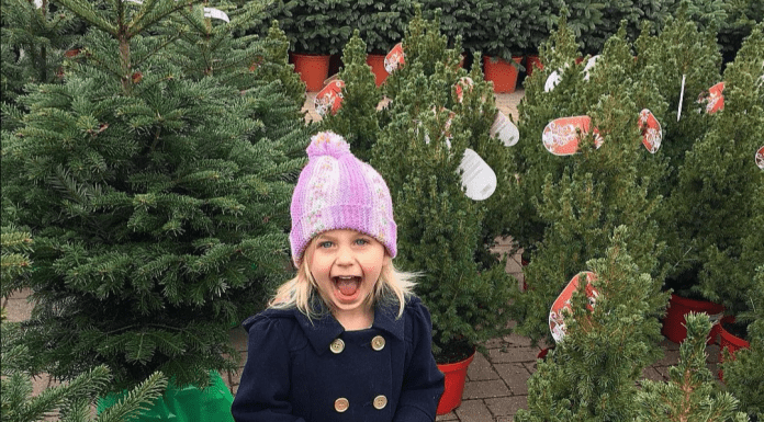 Girl smiling and excited in Christmas Tree lot