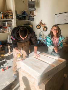 dad and daughter building with wood