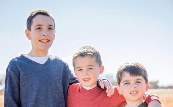 three brothers arms around each other