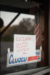 restaurant sign with Closed Until Further Notice on front