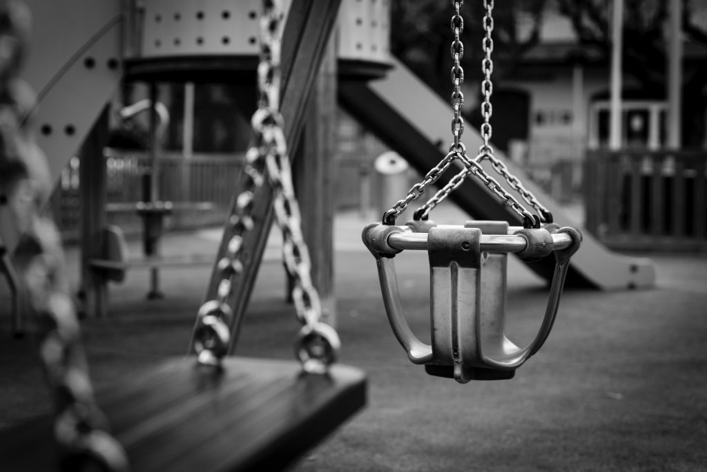 playground swings in black and white