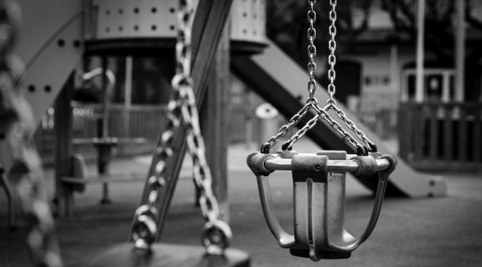 playground swings in black and white