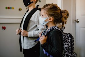 children with masks and backpacks