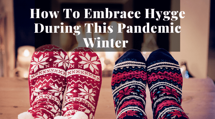 cozy socked feet by fireplace to show hygge