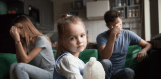 Sticking Together for the Kids? That Might Be a Bad Idea married couple with unhappy child