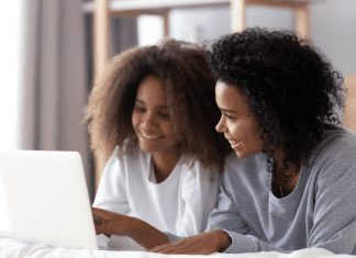 mom and daughter looking on a computer together