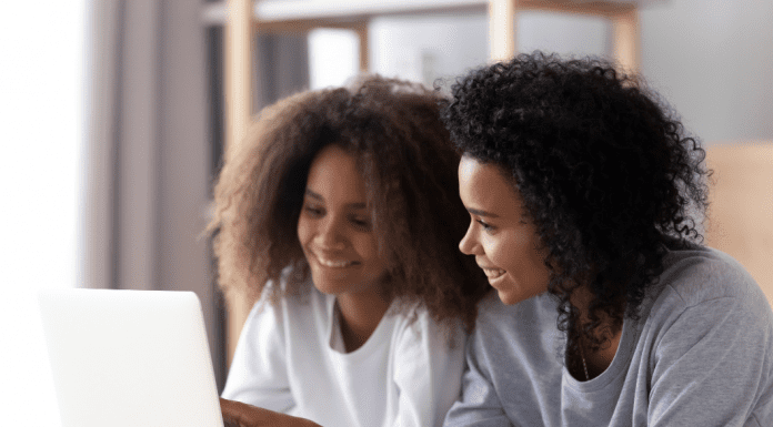 mom and daughter looking on a computer together