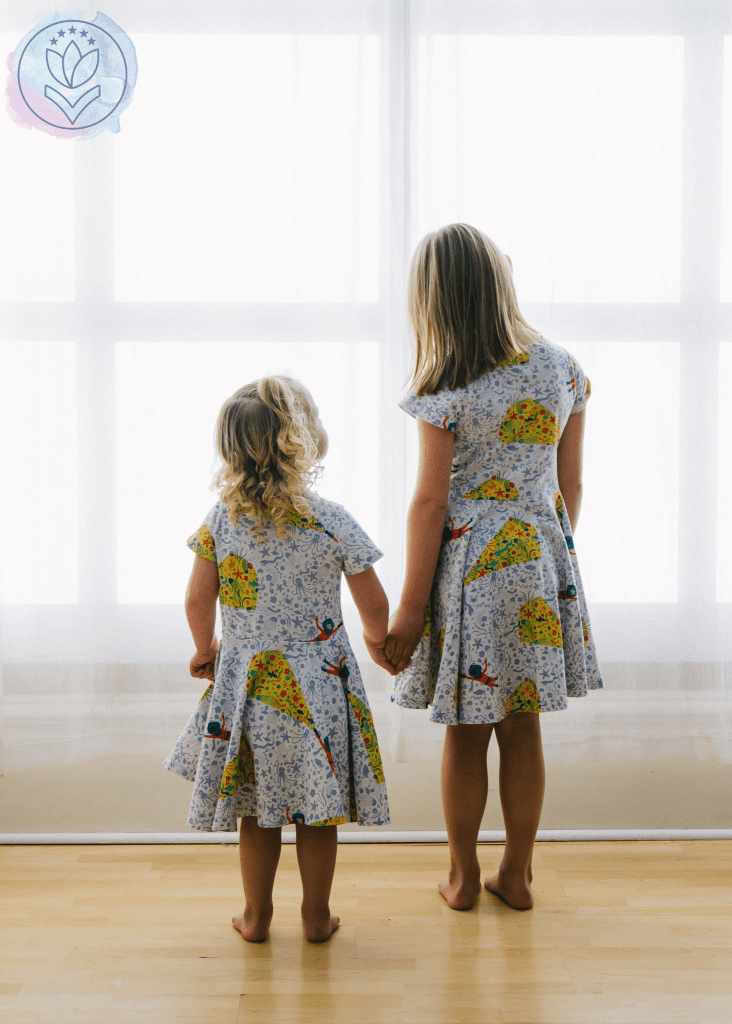 2 daughters standing at a window