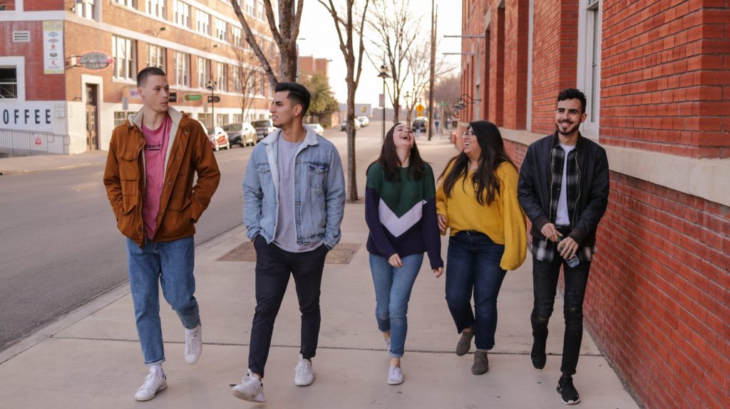 group of teenagers walking on street