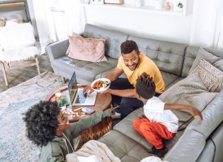 family eating on couch and coffee table