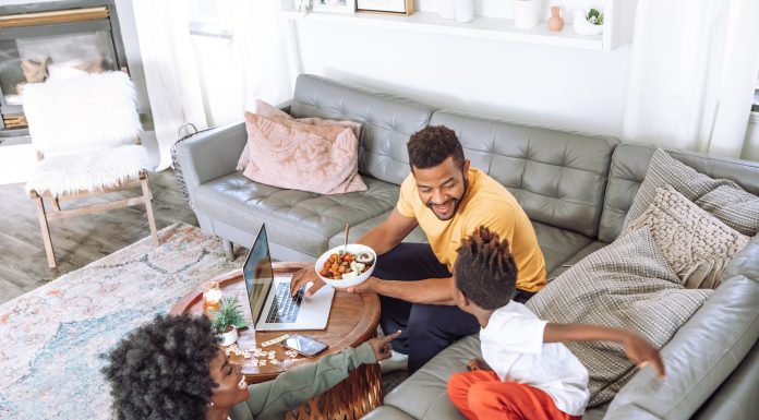 family eating on couch and coffee table