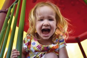 small red-haired girl on a playground