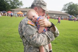 soldier holding a small child